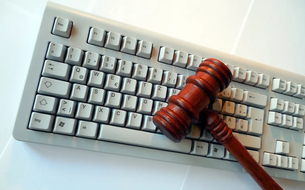A judge's gavel resting on a computer keyboard